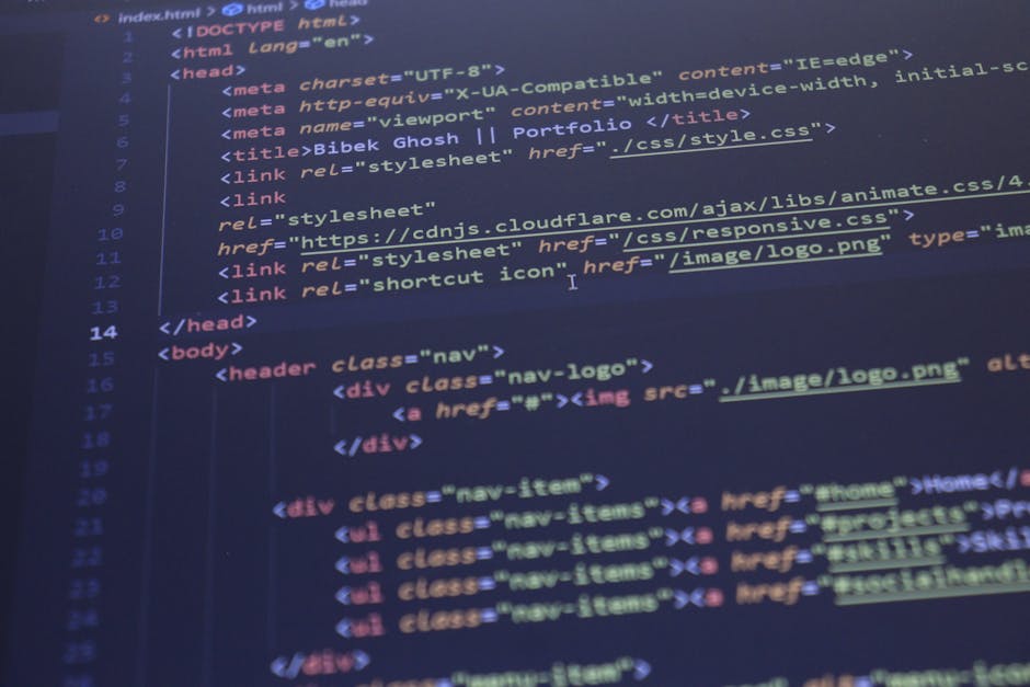 The image displays a close-up of a computer screen with lines of HTML code visible, featuring tags, attributes, and text in various colours such as blue, red, green, and yellow. The code appears to be